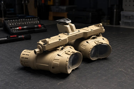 Rear view of a GPNVG-18 quad housing with its two eyepiece pods on a workbench, housing only quad kits explained